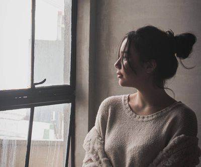 woman looking out window